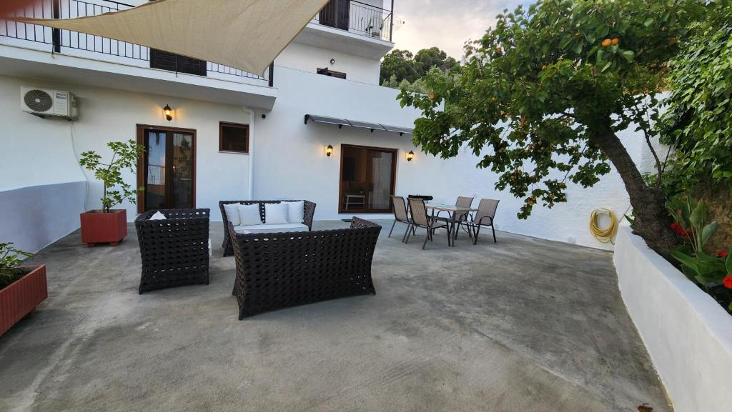 a patio with chairs and a table and a tree at DGK way in Troulos