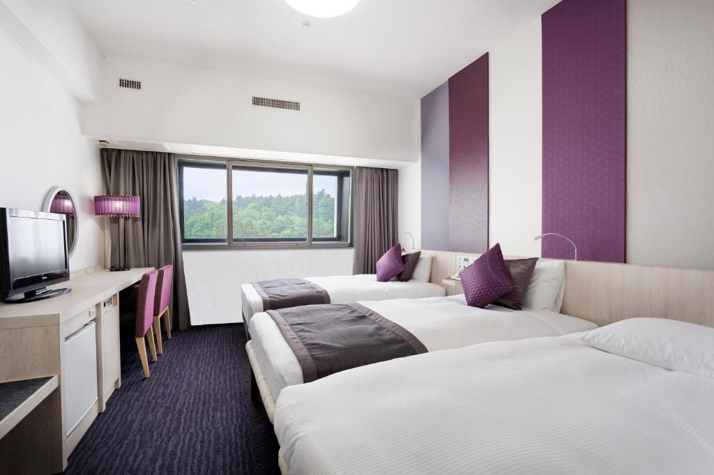 Postel nebo postele na pokoji v ubytování Art Hotel Narita