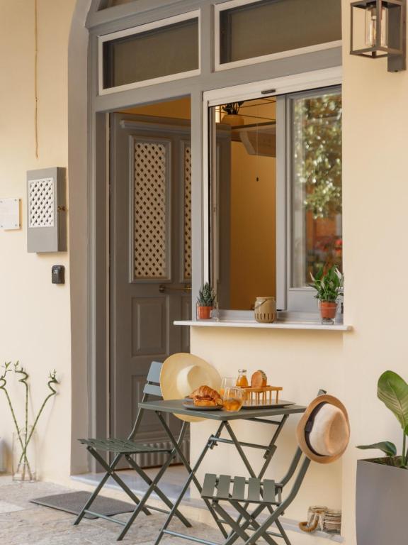 a table and chairs in front of a window at Agnes Loft at Campiello in Corfu