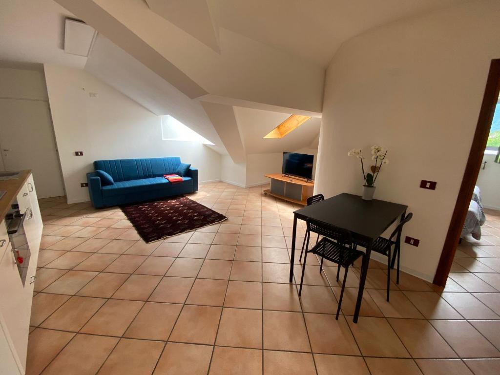 a living room with a blue couch and a table at La Mansarda in Feltre