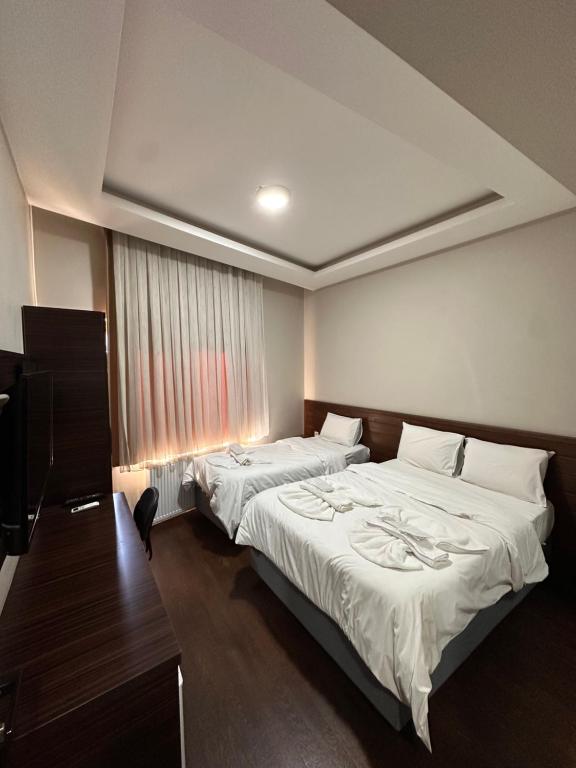 Postel nebo postele na pokoji v ubytování Gold Corner Hotel