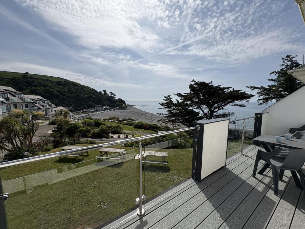 a balcony of a house with a view of the ocean at Sunrise Bay - Mount Brioni in Downderry