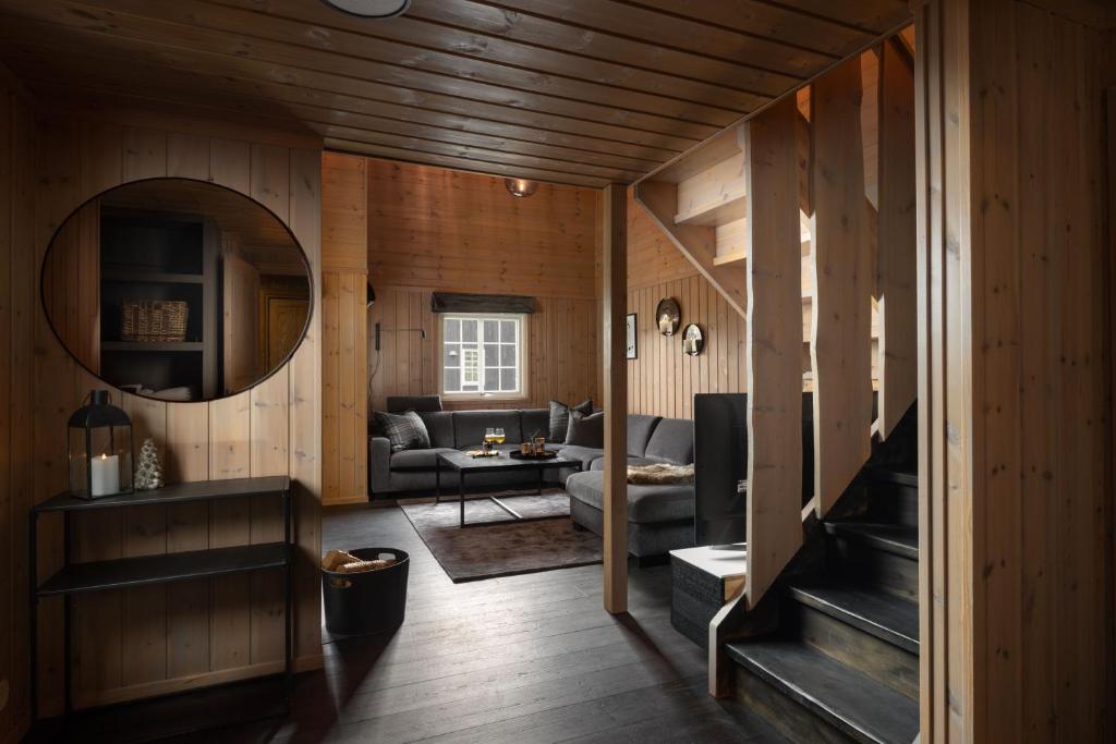 a living room with a couch and a table at 4-Bedroom Ski-In Family Cabin at Geilolia hyttetun in Hol