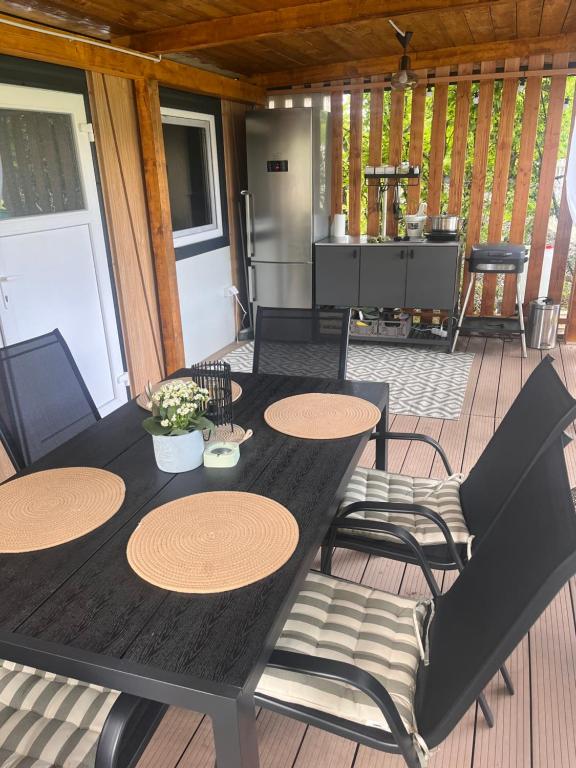 a wooden table and chairs on a deck at Bungalow Camp Velenje in Velenje