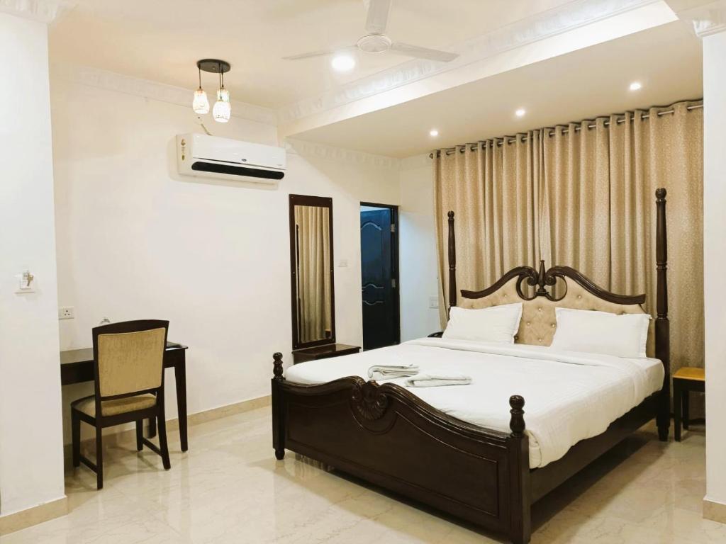 a bedroom with a bed and a desk and a chair at Hotel Jheel Mahal near City Palace in Udaipur