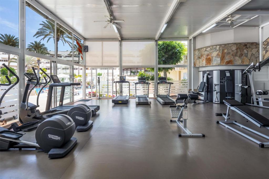 a gym with a lot of treadmills and machines at Barceló Corralejo Bay - Adults Only in Corralejo