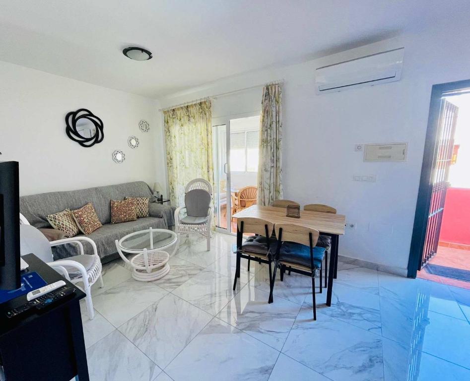 a living room with a couch and a table at SHR043 Nerja Medina Apartamento cerca de Playa Torrecilla in Nerja
