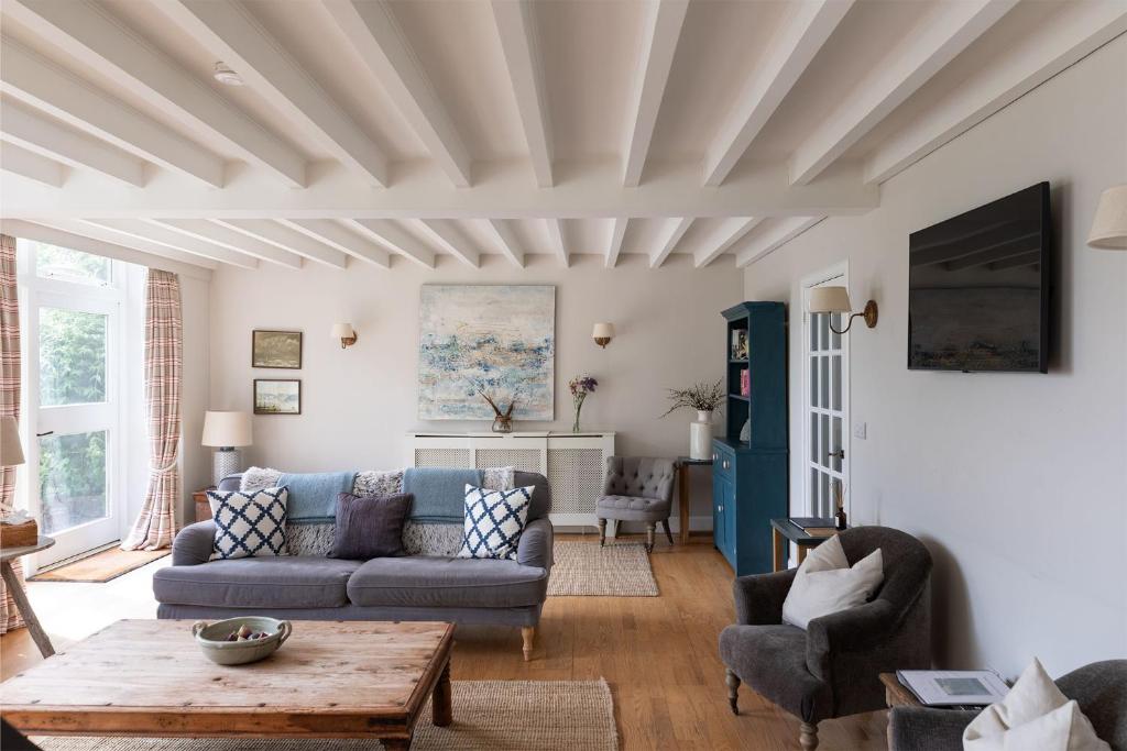 a living room with a couch and a table at The Coach House, Pentland Hills in Nine Mile Burn