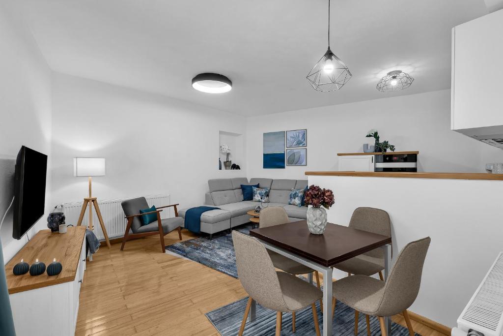 a living room with a table and a couch at Hidden Garden , Stylish Stay in Makarska Old Town in Makarska