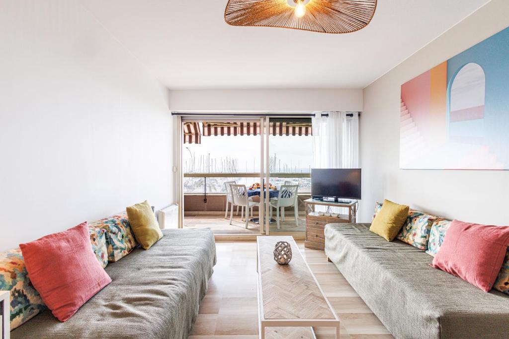un salon avec un canapé et une télévision dans l'établissement ESPACE 2000 - Beautiful 1BDR with sea view - Swimming pool - AC - Parking, à Menton