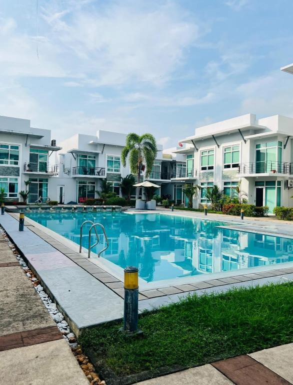 a swimming pool in front of some apartment buildings at Poolside Condo in Subic Bay in Olongapo
