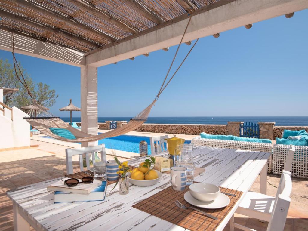 a dining table with a view of the ocean at Domus A B 6 Pax in Portocolom