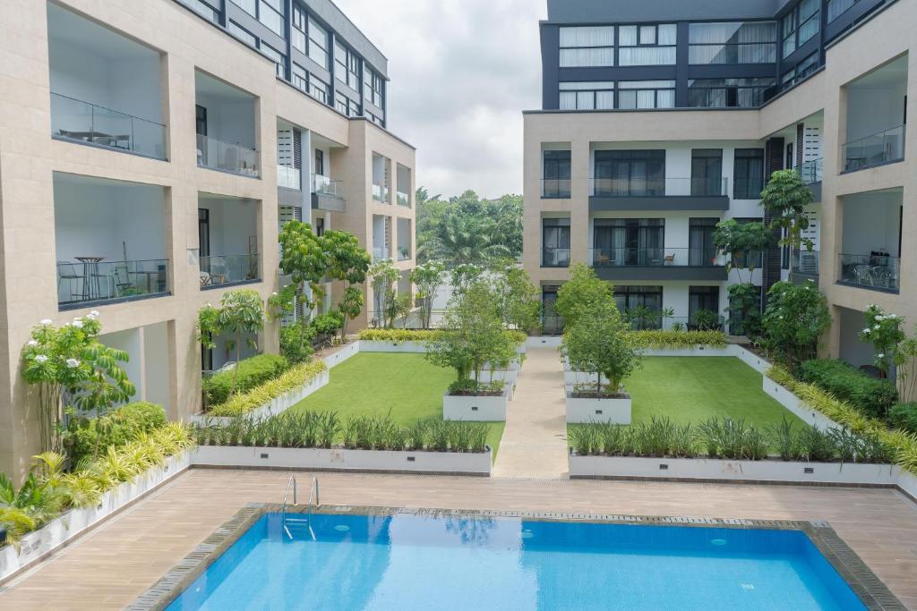 an image of an apartment building with a swimming pool at Oasis Apartments Gh by Embassy Gardens in Accra