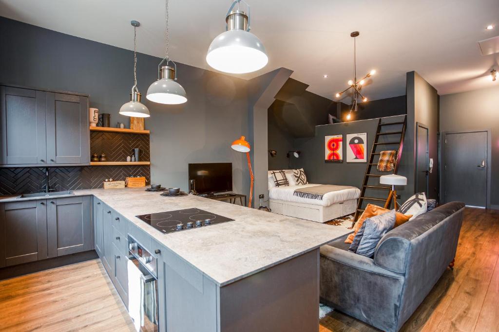 a kitchen and living room with a couch and a table at Large Studio Apartment, Free Parking, Close to Centre in Southend-on-Sea