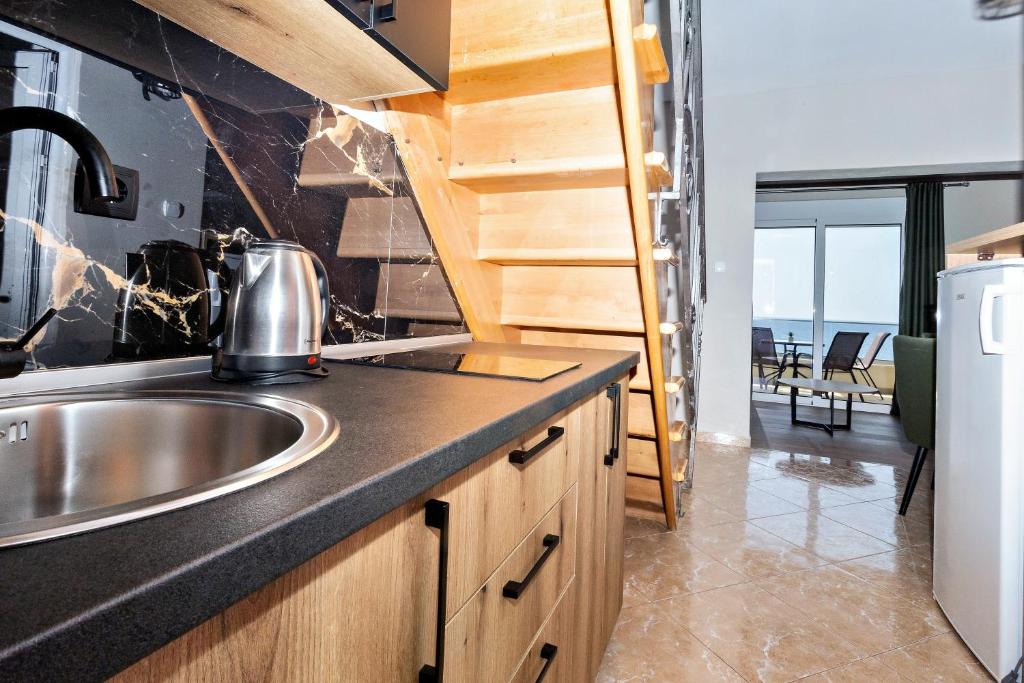 Kuchyň nebo kuchyňský kout v ubytování Apartments Posejdon
