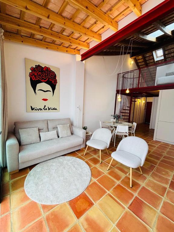 a living room with a couch and chairs and a table at Oliva Lofts & Beach in Oliva