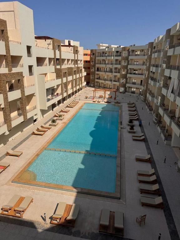 an overhead view of a large swimming pool in a building at Avenuo apartment in Hurghada