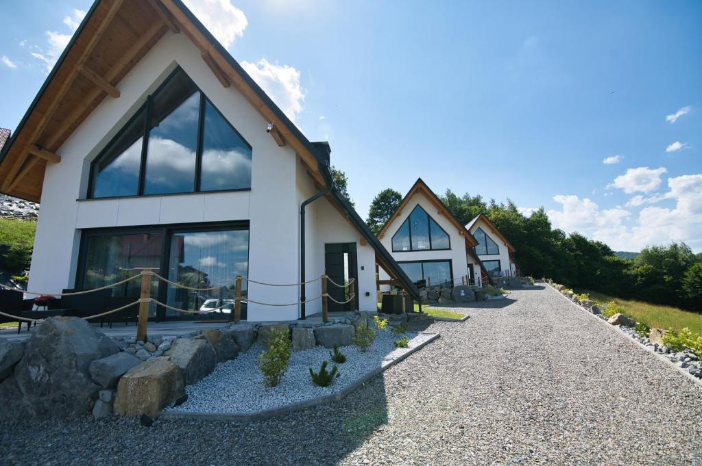 a row of cottages on the side of a mountain at Panorama Hills by Housine in Jaszczurowa