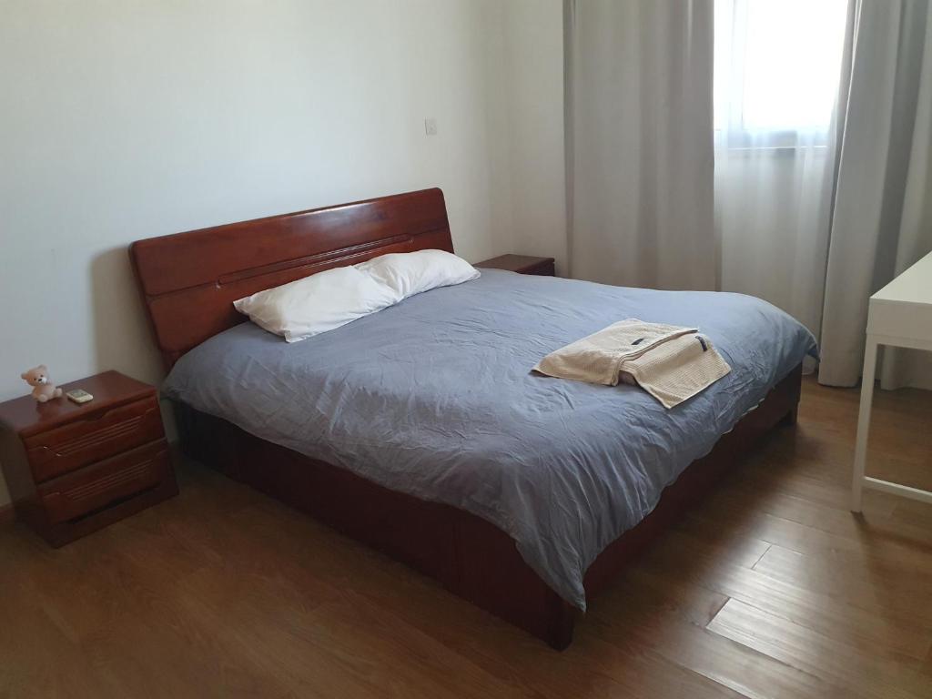 a bedroom with a bed with a wooden headboard at Fantastic sea views in Larnaka