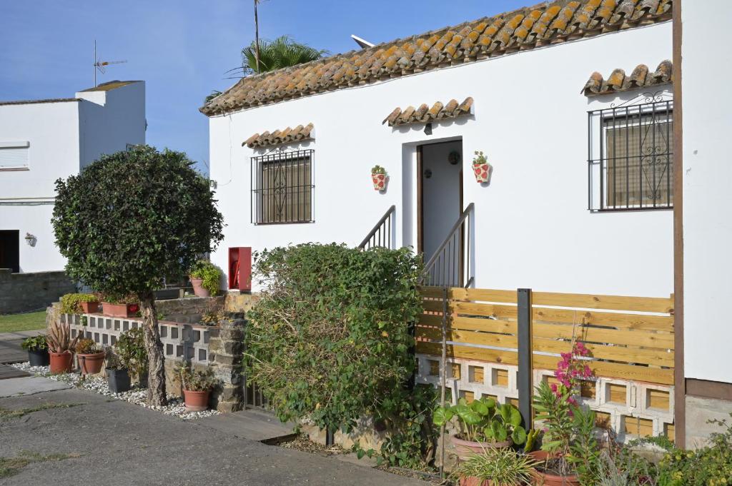 a white house with a wooden fence and plants at Casa Juncal in Tarifa