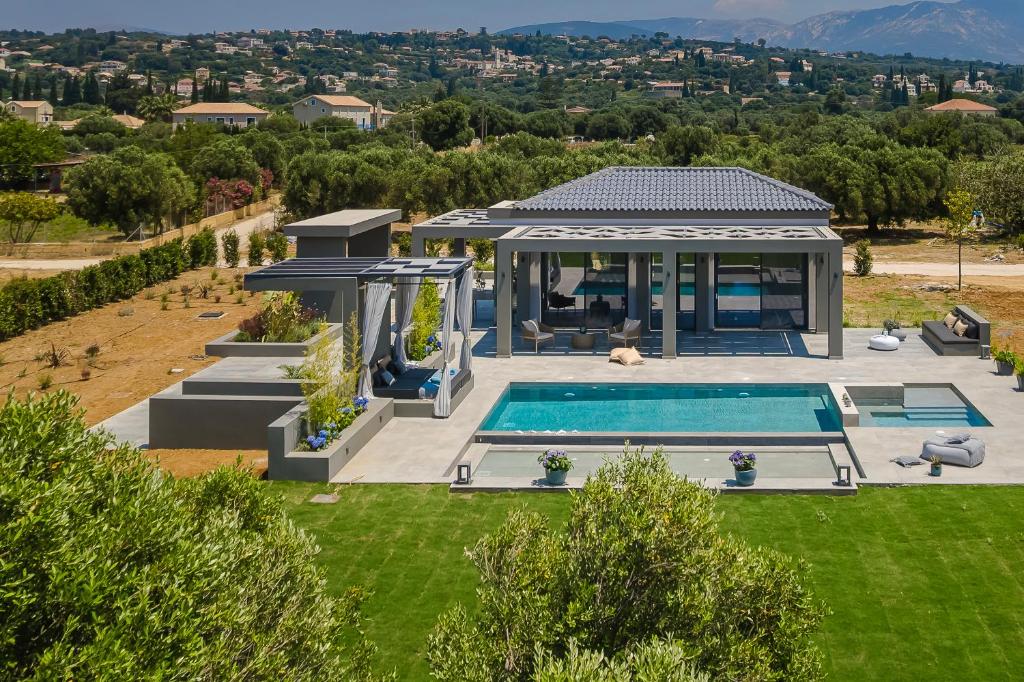 an aerial view of a house with a swimming pool at Aegiali Luxury Villa in Kaligata