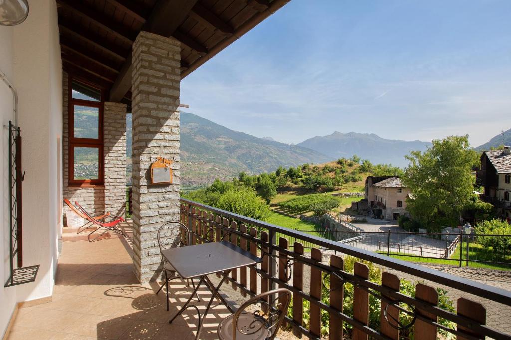 a balcony with a table and a view of a valley at Case Vacanza Newmood - Intera Villa in Aymavilles