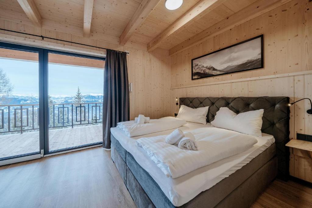 A bed or beds in a room at Clofers Active Apartments Sonnleitn