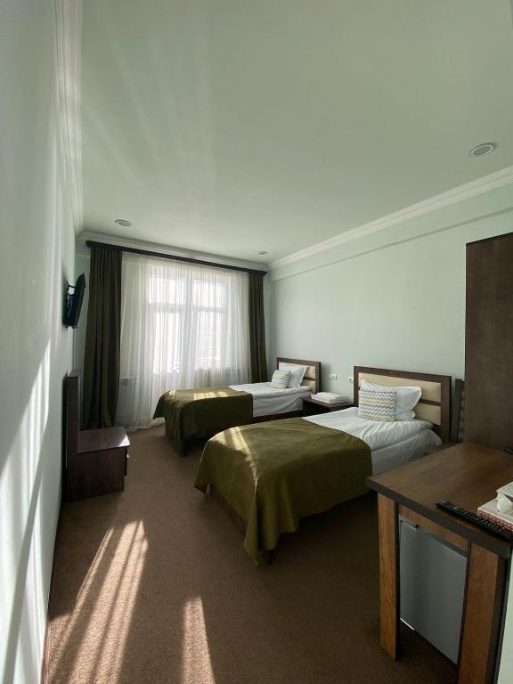 Postel nebo postele na pokoji v ubytování Mina Hotel