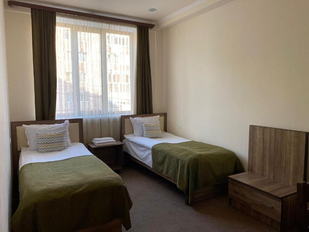 Postel nebo postele na pokoji v ubytování Mina Hotel