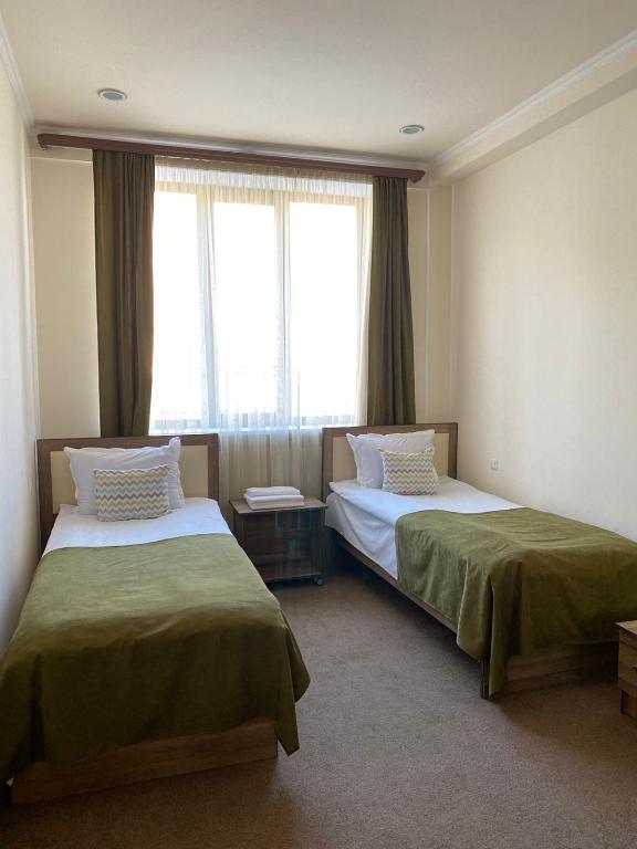 Postel nebo postele na pokoji v ubytování Mina Hotel