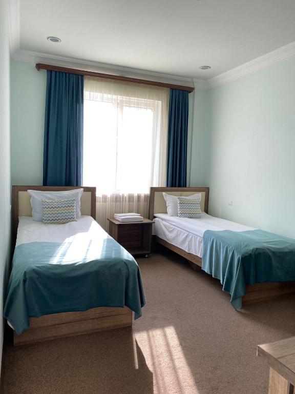 Postel nebo postele na pokoji v ubytování Mina Hotel