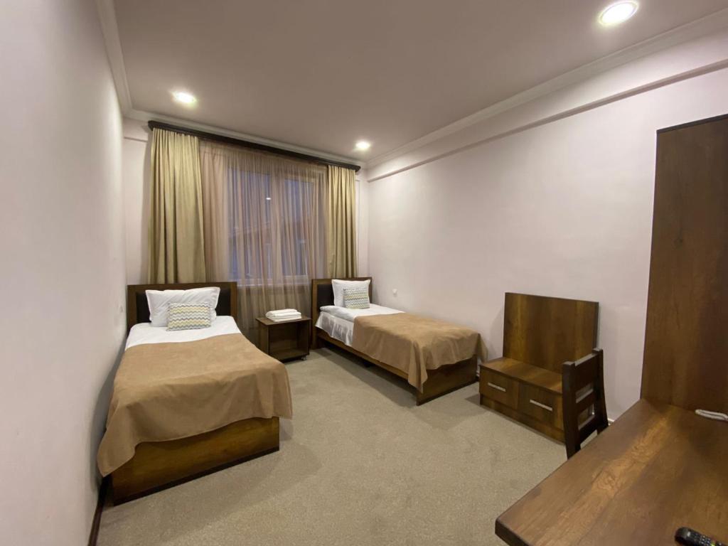Postel nebo postele na pokoji v ubytování Mina Hotel