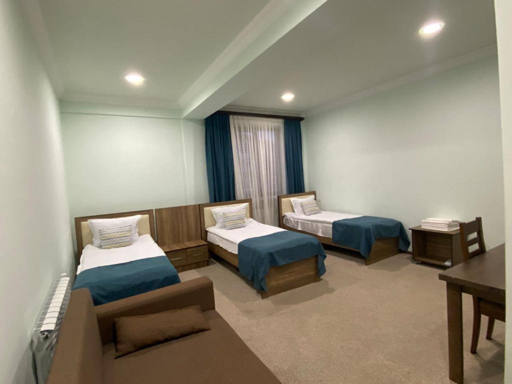 Postel nebo postele na pokoji v ubytování Mina Hotel
