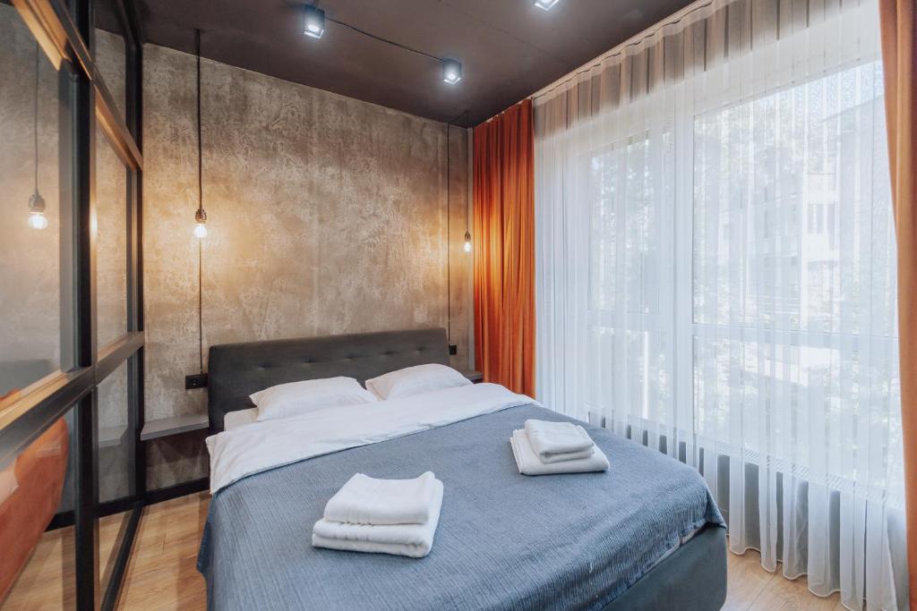 Un dormitorio con una cama con dos toallas encima. en Riscani 1BR Steps to Kaufland and Main Street, en Chişinău