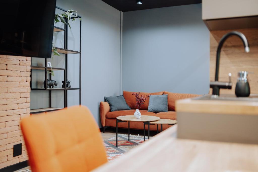 a living room with a couch and a table at Riscani 1BR Steps to Kaufland and Main Street in Chişinău