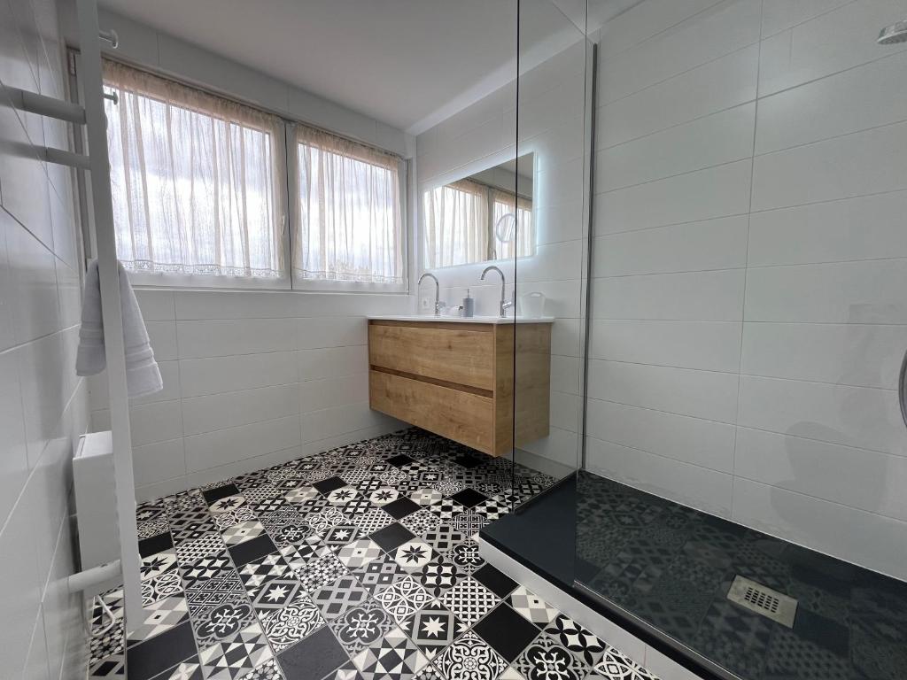 a bathroom with a sink and a mirror at La Cour de Mamama Appartement 4 in Ohnenheim
