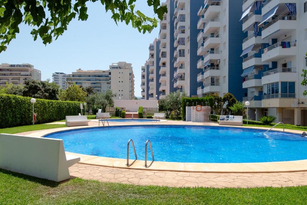 a swimming pool in front of some apartment buildings at Apartamento De Diseño Con Piscina Junto Al Mar GANDIAZAR IV in Playa de Gandia
