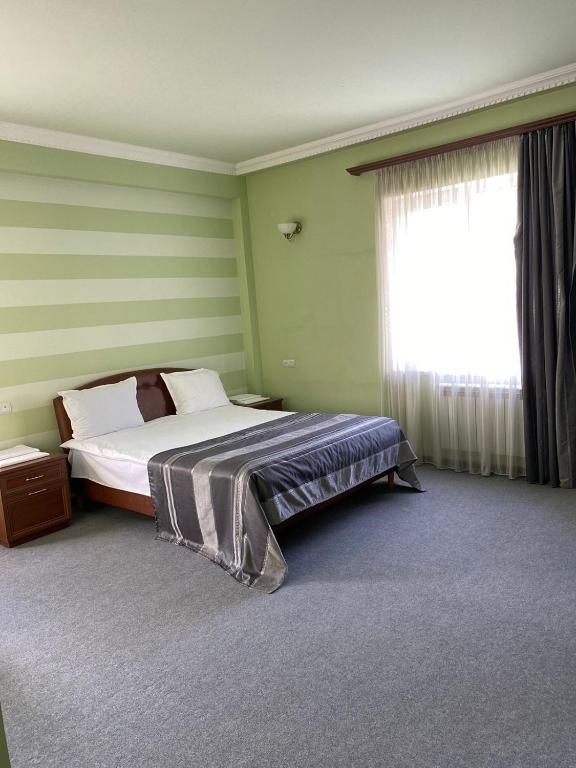 Postel nebo postele na pokoji v ubytování Mina Hotel