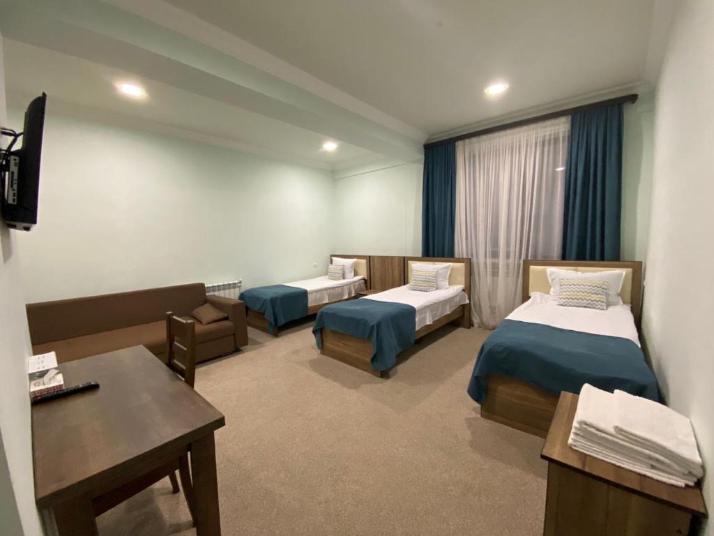 Postel nebo postele na pokoji v ubytování Mina Hotel