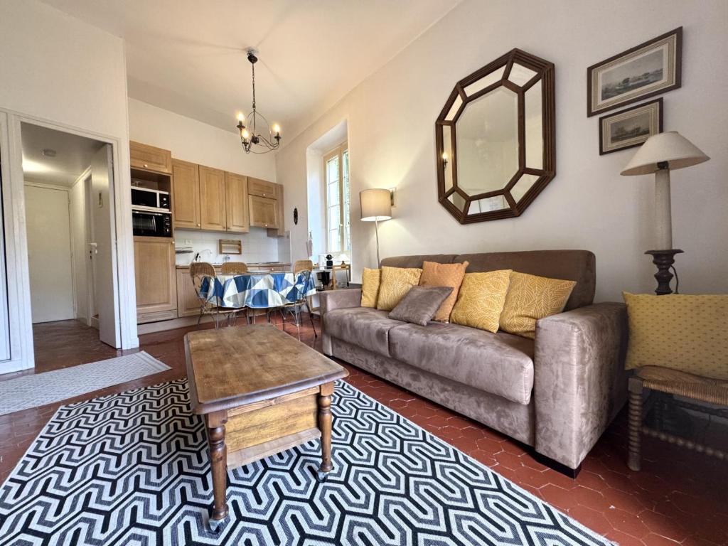 un salon avec un canapé et une table dans l'établissement ApartHotel Riviera - BALCON HONORE 1 - Old Town - 5 mn Promenade des Anglais et Plage - Charme Absolu - Appartement 2 pièces avec Balcon AC - Vue mer et Ville, à Nice