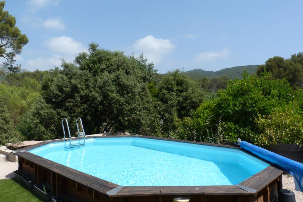a pool in a yard with trees in the background at Chambre d'hôte, SdB & accès privé, piscine, jardin in Gémenos