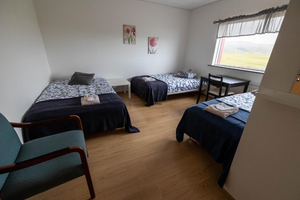 a room with three beds and a window at Grund í Grundarfirði Economy Guesthouse in Grundarfjordur