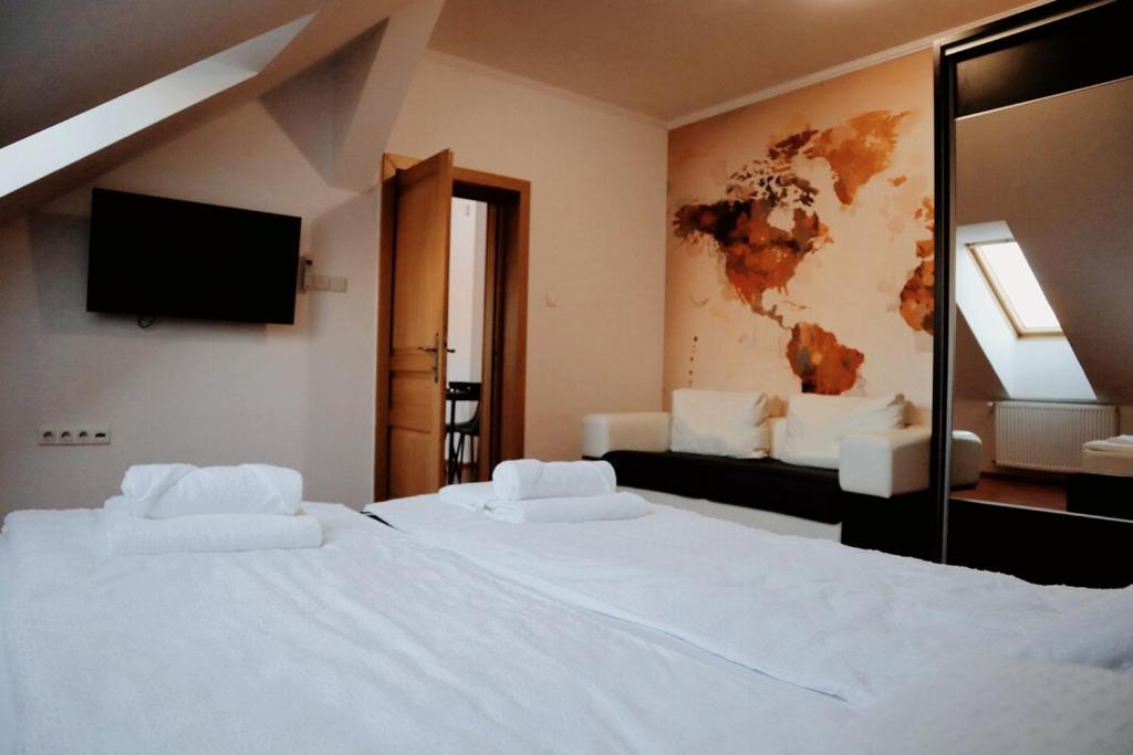 a hotel room with two beds and a tv at TOTO's apartment in Gheorgheni