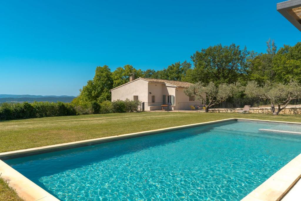 une piscine devant une maison dans l'établissement Sur les hauteurs du Luberon, à Cucuron