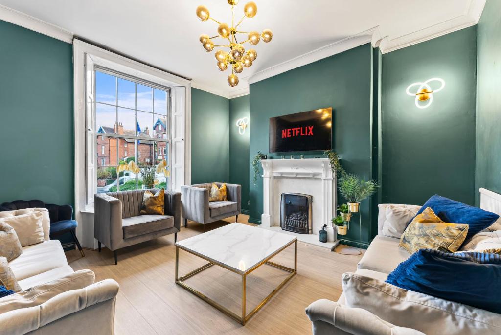 a living room with green walls and a fireplace at New! - The Most Central and Lux Whitby House - Hot-Tub in Whitby