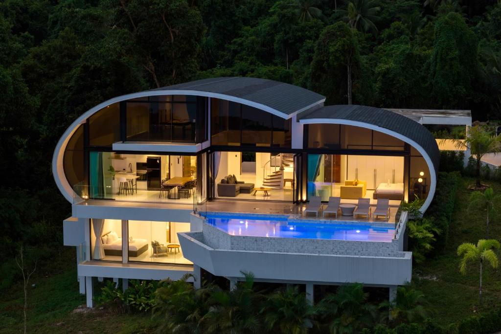 a large house with a round roof with a pool at Seaview Dream Villa in Chaweng Noi Beach