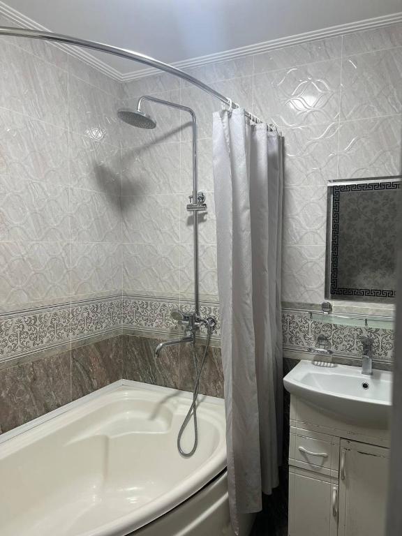 a bathroom with a shower and a tub and a sink at Старый Город гостница in Tashkent