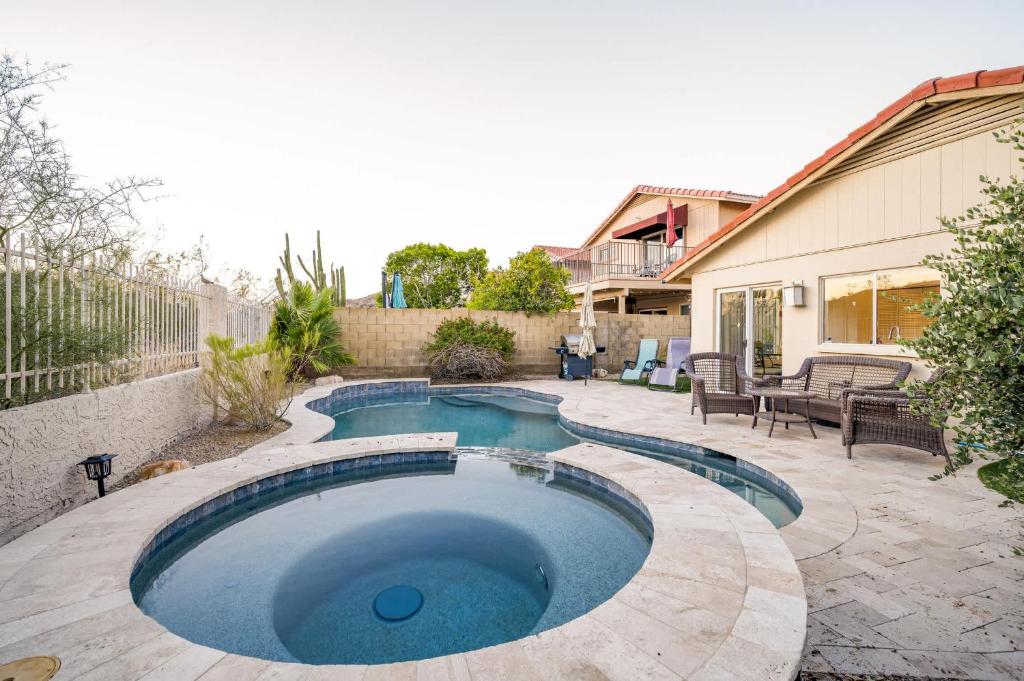 a swimming pool in a yard with a patio at Desert View Home Pool & Hot Tub in Phoenix
