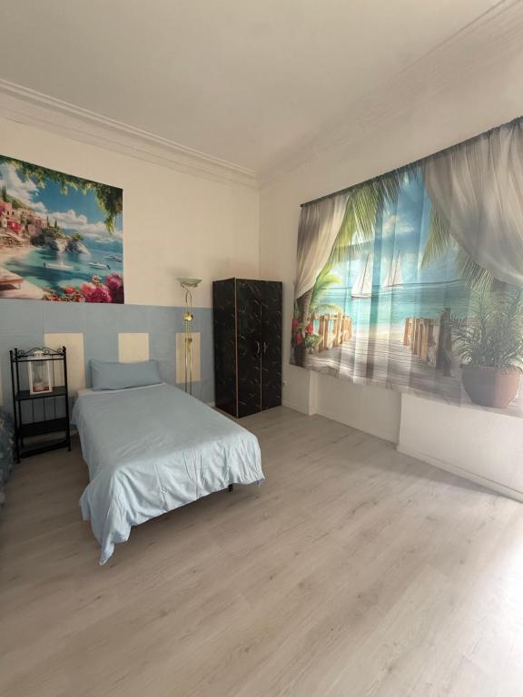 a bedroom with a bed and a large painting on the wall at Ferienzimmer Healing und Montuerwohnung in Weißenfels