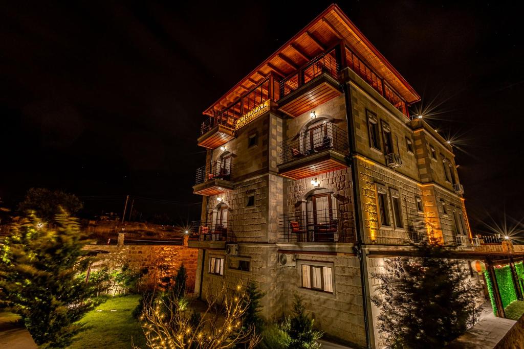 a tall building with lights on it at night at Cordial Cappadocia Hotel in Ortahisar